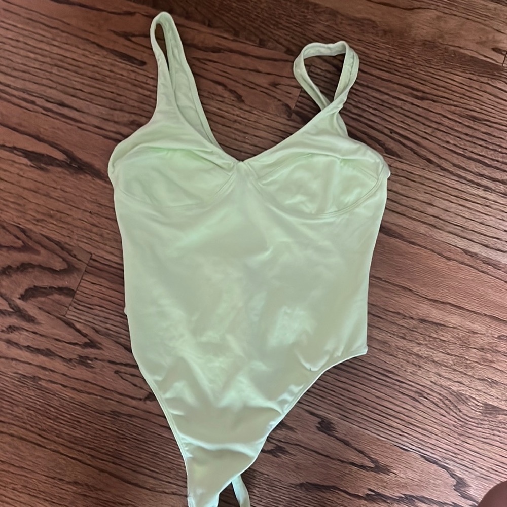Urban Outfitters out from under green bodysuit